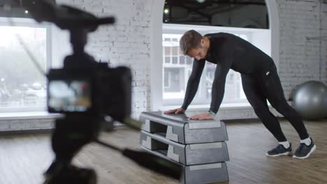 Gym-Coach-Showing-Evaluated-Push-Ups-on-Camera