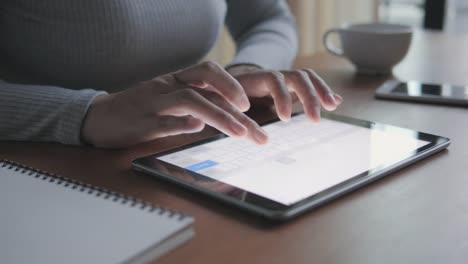 The-fingers-of-a-woman-is-typing-on-a-tablet.-it's-item-high-technology-innovation.