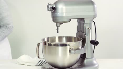 Mixing-royal-icing-in-electric-kitchen-mixer-for-Easter-cookies.