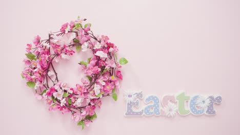 Easter-sign-with-flower-wreath-on-a-pink-background.