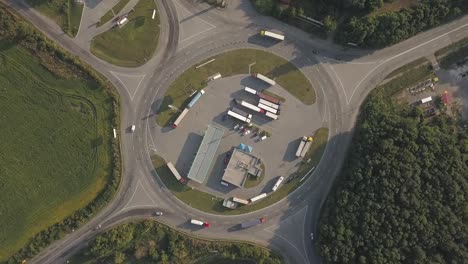 Aerial-high-drone-in-4K-flight-over-evening-road-traffic-in-Kiev,-Ukraine.-Highway-and-overpass-with-cars-and-trucks,-interchange,-two-level-road-junction-in-the-big-city.-Top-view.