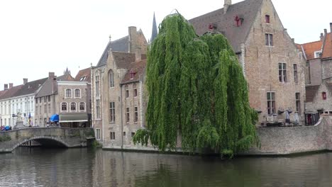 Bruges,-Belgium---May-2019:-View-of-the-water-channel-in-the-city-center.-Boat-trip-along-the-water-canals-of-the-city.