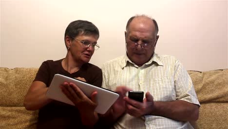 Attractive-adult-woman-and-adult-man-work-on-tablet-pc-and-smartphone.