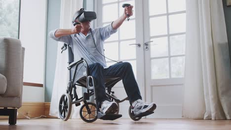 Senior-Disabled-Man-In-Wheelchair-At-Home-Wearing-Virtual-Reality-Headset-Holding-Gaming-Controller