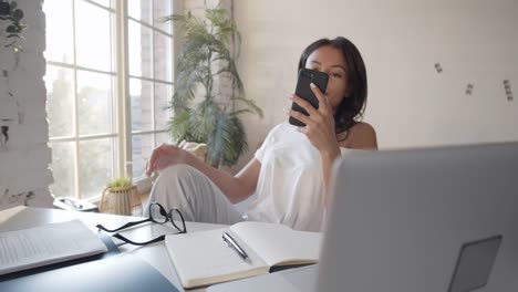 Frau,-die-während-der-Arbeit-zu-Hause-telefoniert