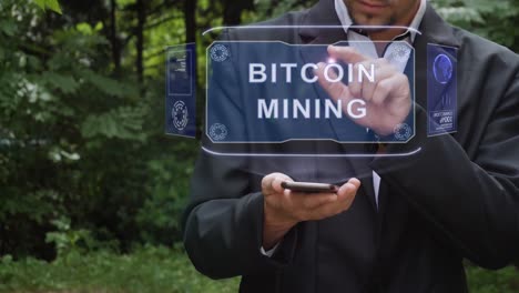 Businessman-uses-hologram-with-text-Bitcoin-Mining