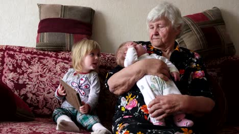 Grandmother-is-rocking-little-baby-on-her-arms