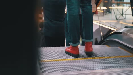 Legs-of-People-Moving-on-an-Escalator-Lift-in-the-Mall.-Shopper's-Feet-on-Escalator-in-Shopping-Center