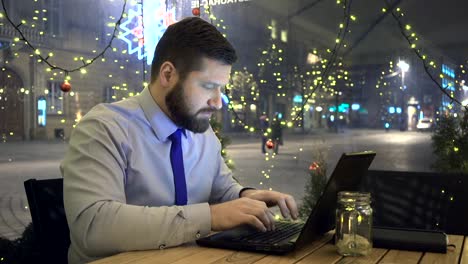 Businessman-writing-on-laptop,-look-at-camera,-cafe,-evening