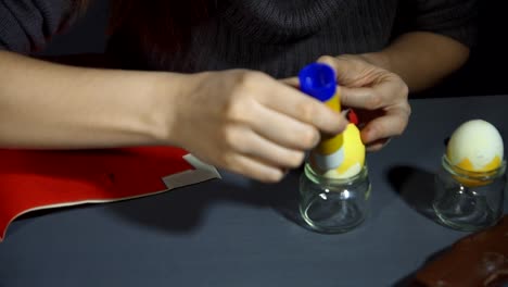 Creating-easter-chicken-from-the-shell-by-hand-on-a-grey-table.