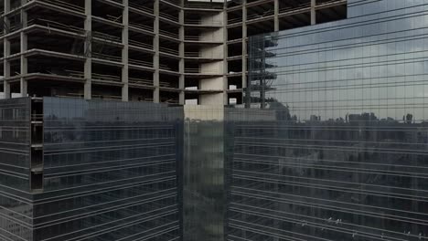 Unfinished-skyscraper-with-a-glass-facade.-The-camera-moves-up.-Aerial-view