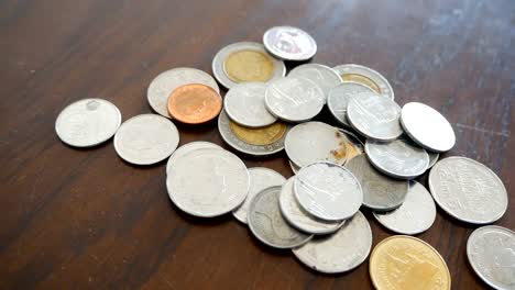 Thailand-coins-on-wood-floor