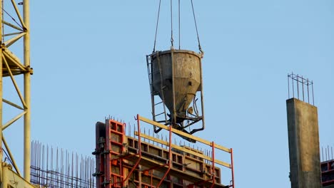 Crane-carrying-concrete-for-pouring-walls-and-partitions-at-housing-estate