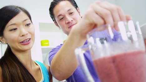 Asian-Chinese-couple-preparing-healthy-homemade-fruit-smoothie