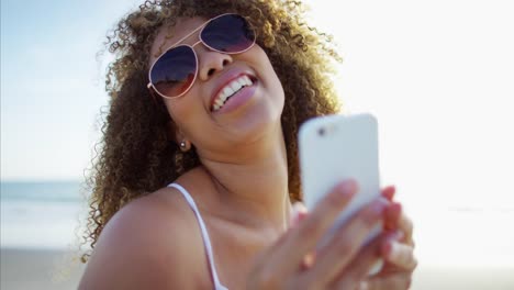 Plus-size-Ethnic-female-taking-selfie-on-beach