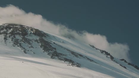 Picturesque-view-of-clouds-floating-over-hight-mountain-peak