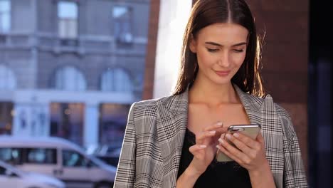 Beautiful-Business-Woman-Using-Mobile-Phone-Outdoor-On-Sunny-Day