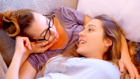 Lesbian-couple-interacting-with-each-other-in-living-room-4k