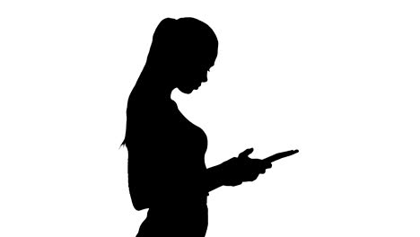 Silhouette-Beautiful-young-adult-womann-having-fun-playing-game-with-tablet