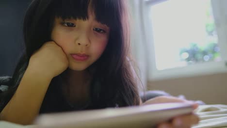 Cute-Little-Girl-in-Her-bed-Room-at-morning,-Lies-on-a-Bed-Uses-Smartphone-to-watching-cartoon.