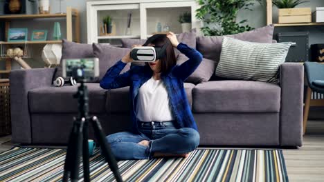 Cute-vlogger-recording-video-about-vr-glasses-wearing-device-and-talking-at-home