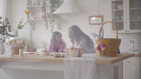 Young-mother-and-her-pre-teen-daughter-arguing-on-the-kitchen.