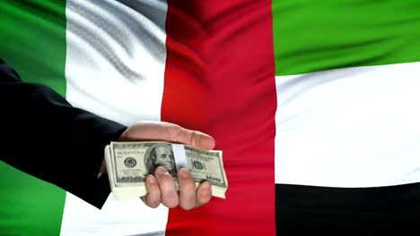 Italy-and-UAE-officials-exchanging-tank-money,-national-security-flag-background