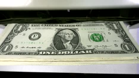 Electronic-money-counter-machine-is-counting-is-counting-the-American-hundred-dollar-US-dollars-banknotes