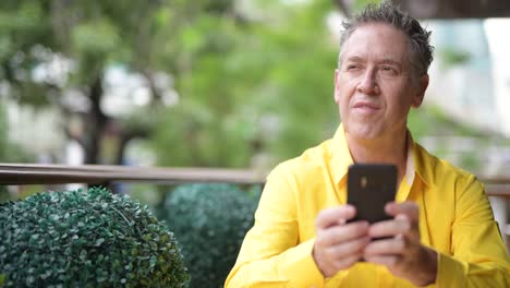 Mature-handsome-man-relaxing-at-the-coffee-shop