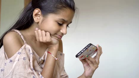 Indian-little-girl-is-Watching-cartoon-on-smartphone