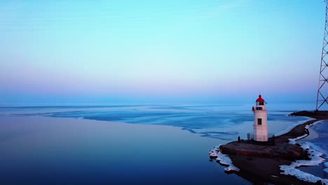 Aerial-winter-view-of-the-Tokarevskiy-lighthouse---one-of-the-oldest-lighthouses-in-the-Far-East,-still-an-important-navigational-structure-and-popular-attractions-of-Vladivostok-city,-Russia.