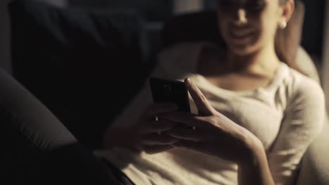 Happy-girl-chatting-late-at-night-with-her-smartphone