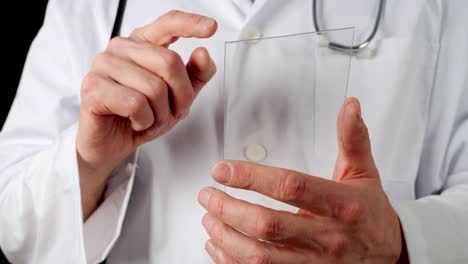 Cropped-view-of-doctor-sliding-on-transparent-tablet-screen