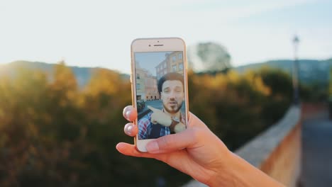 Man-speaking-on-video-call-on-smartphone