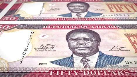 Banknotes-of-fifty-dollars-of-the-bank-of-Liberia-rolling-on-screen,-coins-of-the-world,-cash-money,-loop