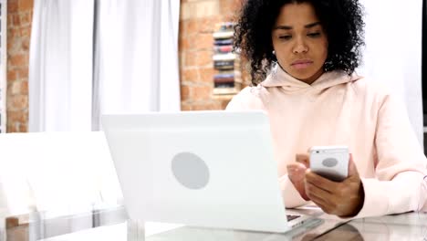 Afro-American-Woman-Browsing-Online-on-Smartphone,-Typing-Message