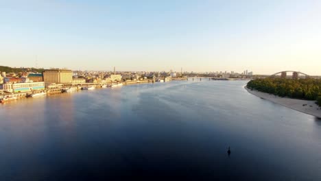 Wonderful-view-of-city-from-above.-Big-city-with-bridge-over-river-and-lot-of-green-trees.-Overcast.-Spring.-kiev