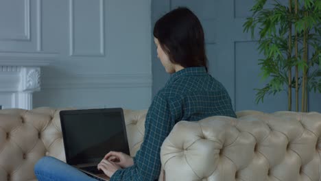 Charming-woman-networking-on-laptop-at-home