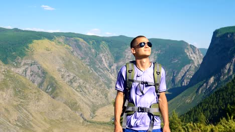 A-tourist-with-a-backpack-in-the-mountains.