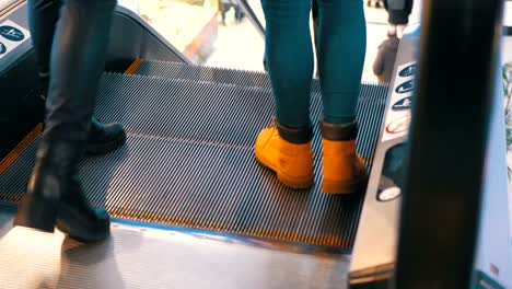 Legs-of-People-Moving-on-an-Escalator-Lift-in-Shopping-Center