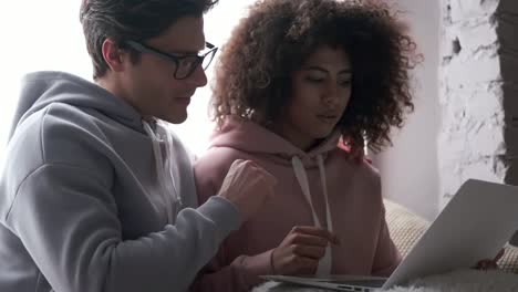 Couple-using-laptop-at-home