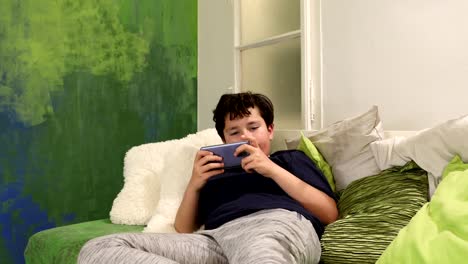 Portrait-of-a-young-boy-paying-video-games-at-home