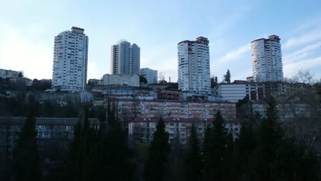 Timelapse-movement-of-clouds-over-the-houses-in-the-city.-Sunset-over-the-city.-In-the-Windows-of-houses-lights-up