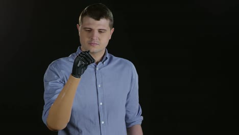 Man-with-Prosthetic-Arm-Posing-on-Black-Background