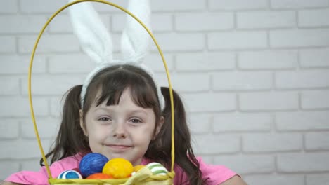 Cheerful-child-with-a-basket-of-Easter-eggs.