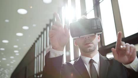 Medium-shot-of-modern-businessman-in-suit-and-tie-wearing-VR-glasses-and-exploring-visualization-in-sunlight