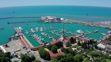 Aerial-video-shooting.-Panoramic-view-of-the-sea-port-of-Sochi,-Russia.-Luxury-yachts-and-boats-are-in-the-Bay.-The-view-from-the-top.-City-attraction.-Black-Sea.