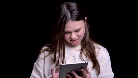 Closeup-shoot-of-young-attractive-caucasian-female-texting-on-the-tablet-in-front-of-the-camera