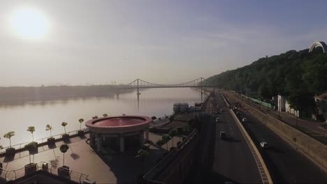 Early-morning-highway-traffic-aerial-shot-in-Kyiv-Ukraine-near-river-Dnipro