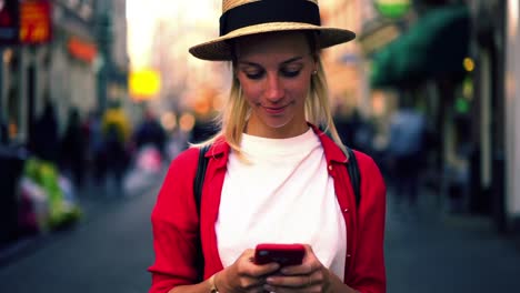 low-motion-effect-if-Caucasian-authentic-female-holding-smartphone-in-hands-and-sincerely-smiling-after-read-text-message-on-mobile-phone